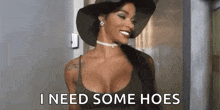 a woman wearing a hat and choker is smiling and says `` i need some hoes '' .