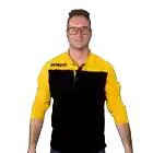a man wearing a jumbo shirt is holding a basket full of groceries
