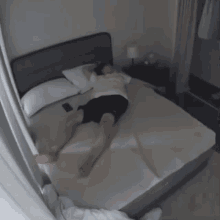 a person is laying on a bed with korean writing on the wall