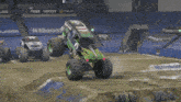 a monster truck is doing a trick on a dirt track