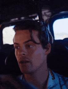 a man is sitting in a car and says we just got that now