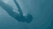 a person is swimming in the ocean and looking up