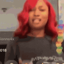 a woman with red hair is wearing a black shirt with the number 8 on the front