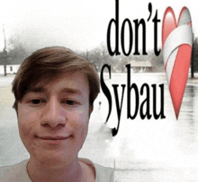 a young man stands in front of a sign that says " don 't sybau "