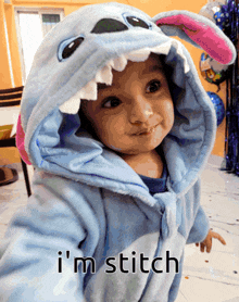 a baby in a stitch costume says i 'm stitch on the bottom
