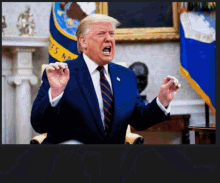 a man in a suit and tie screams in front of a flag that says ' united states of america '