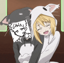 a girl in a cat hoodie is being hugged by a black cat