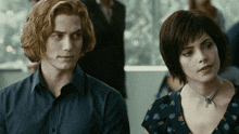 a man and a woman are looking at each other