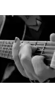 a close up of a person playing a guitar