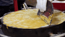 a person is using a spatula on a pan that says made in animonica