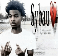 a black and white photo of a young man with sybau written on the top