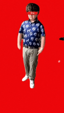 a man wearing a shirt that says drip is standing on a red background