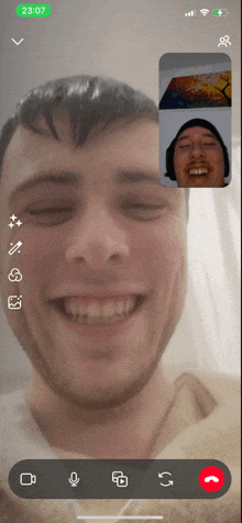 a phone screen shows a man and another man having a video call at 3:07