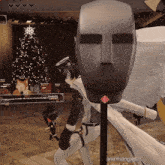 a christmas tree is behind a mannequin with anayoongles written on the bottom
