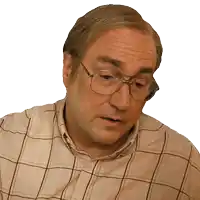 a man wearing glasses and a plaid shirt is looking at the camera
