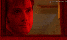 a close up of a man 's face with a red light behind him and the hashtag itsscottiesstark