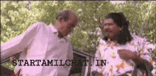 two men are standing next to each other in front of a car with the words startamilchat in the bottom right corner .