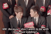 a group of men in suits and ties are talking to each other while holding stuffed animals