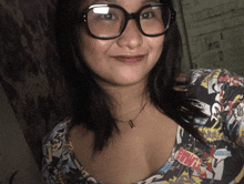 a woman wearing glasses and a comic book shirt with the word boom on it