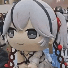 a close up of a stuffed doll with a ponytail and braids