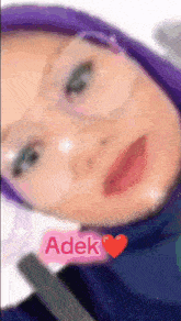 a close up of a woman 's face with a pink heart and the name adek on it
