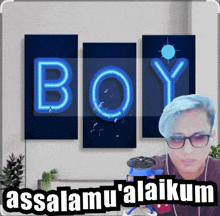 a man with blue hair is standing in front of a wall with the word boy written on it