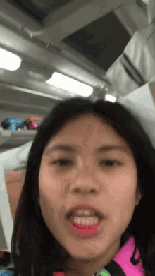 a close up of a woman 's face with her mouth open and her teeth showing