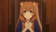 a girl with long brown hair and bear ears is smiling with her hands folded