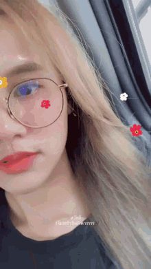 a close up of a woman wearing glasses with flowers on them