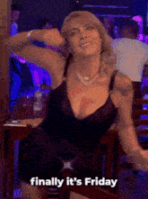 a woman in a black dress is dancing with the words finally it 's friday
