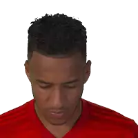 a man in a red shirt looks at the camera