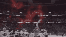a group of hockey players are celebrating a goal on a rink .