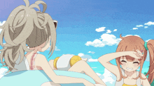 a girl in a bikini is splashing another girl in the face