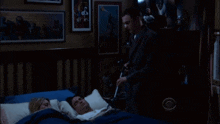 a man standing next to a man laying in a bed with the words i knew it written on the bottom