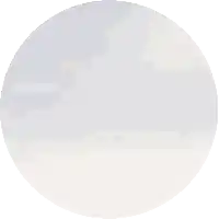 a pixelated image of a mountain in a circle with a blue sky in the background