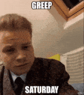 a man in a suit and tie with the words greep saturday above him