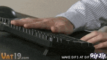 a person is typing on a keyboard with a make gifs at gifs gif on the bottom right