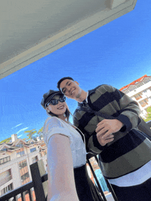 a man and a woman are posing for a picture together