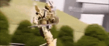 a robot with a sword is standing in front of a building holding a sword .
