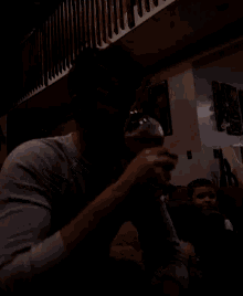 a man with a beard is drinking from a glass