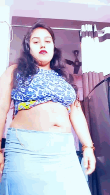 a woman wearing a blue top and a blue skirt