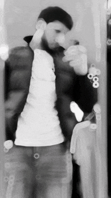 a man is taking a picture of himself in a mirror with the number 8 on his wrist