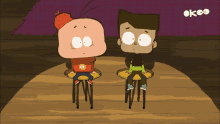 two cartoon characters are sitting on a wooden table in front of a sign that says okco
