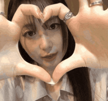 a woman making a heart with her hands