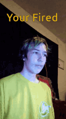 a young man with green hair is being fired