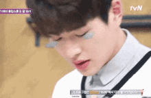 a close up of a person 's face with tvn written on the bottom
