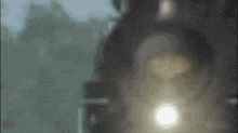 a close up of a train 's headlight with a blurred background