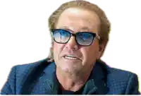 a man wearing glasses and a blue suit is making a face .