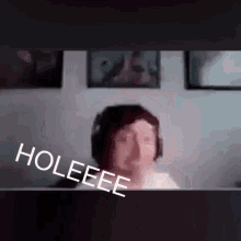 a blurry picture of a person with the words holeeee written on the bottom