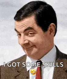 mr bean is wearing a suit and tie and making a funny face .